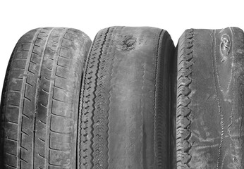 old worn out tire next to another old tire isolated on white background