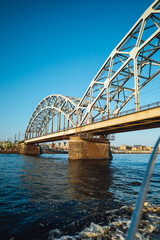 Large metal train bridge over river in the city of Riga, Latvia