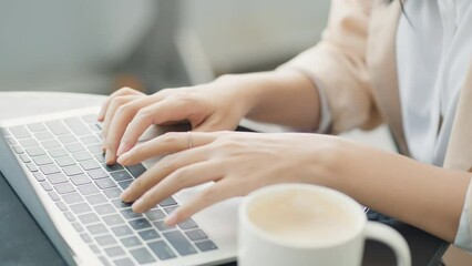 Beautiful asian young adult businesswoman wearing headset to listening music while working at outdoor co-working space in urban city, work anywhere lifestyle. - Powered by Adobe
