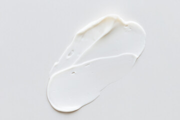 Swatch of white cream texture, cosmetics for face and body on a isolated light grey background. Smear. Real photo