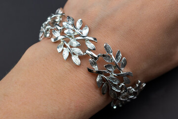 Beautiful old silver leaves bracelet, unique vintage jewelry background, floral jewelry concept, promotional photo for an online jewellery store