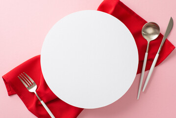 Elegant table arrangement showcasing premium silverware and a vibrant red napkin. The pastel pink backdrop creates a sophisticated setting, with empty circle offering space for personalized text or ad