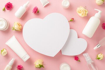 Feminine natural skincare concept. Top view flat lay of pump bottle, pipette, cream bottles and tubes with rose flowers on pastel pink background and two empty hearts for branding