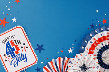 Idea for patriotic festivities on USA Independence Day. Top view flat lay of party decorations, red, blue, white stars on blue background with blank space for promo or greeting message