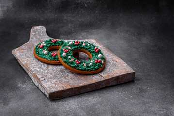 Delicious beautiful Christmas gingerbread cookies on a textured concrete background