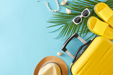 Travel oriented summer holiday concept. Top view flat lay of yellow suitcase, beach accessories,...