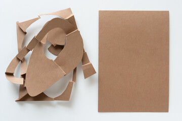 plain and cut brown paper cards with abstract forms on white