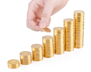 Hand with coin and columns of gold coins isolated on white background.