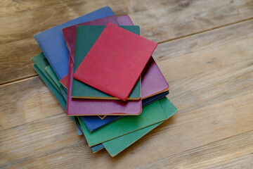 stack of old personal documents on wooden table, passports, diplomas, licenses, social certificates, citizen of USSR middle of twentieth century, bureaucracy concept, family archive for social service
