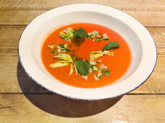 Traditional Spanish gazpacho soup in bowl on wooden table