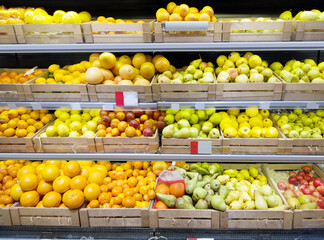buying fruits(grape,bananas, apples, pears, lemons, orange, lime, tangerine)  at the market