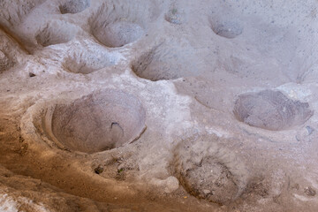 Clay amphoras in a stone floor of wine cellar in Vardzia Cave monastery complex, Georgia.