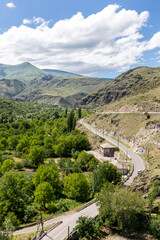Fototapeta na wymiar Winding tarmac road (historic silk road) through Khertvisi village in Mtkvari river valley in Lesser Caucasus Mountains, Samtskhe - Javakheti region, Georgia, seen from Khertvisi fortress.