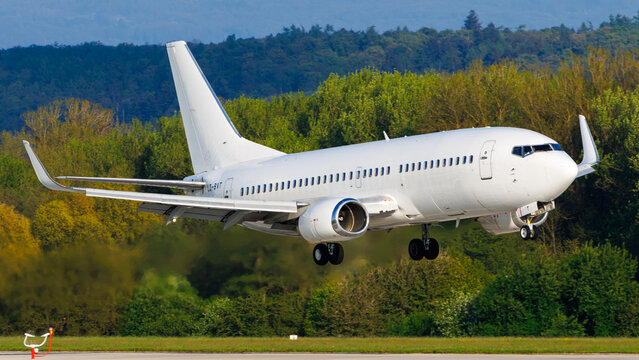 Bul Air Boeing 737-300 white plane in final approach in front of forest; May 2, 2023