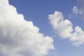 blue sky with diagonal fluffy clouds