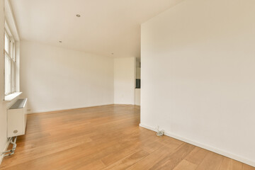 an empty room with wood flooring and white walls in the room is very clean, but there is no light