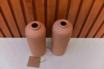 clay pot on a wooden background, decoration with crafts,clay objects, rustic decorative objects, handmade, decoration with ceramics
