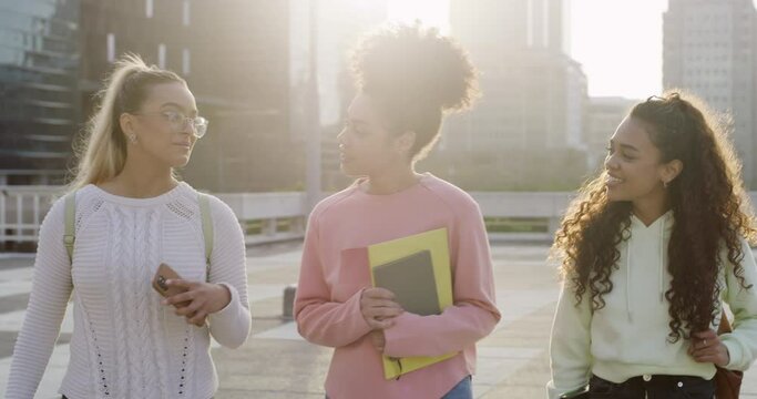 Walking, university students and women laughing in city at joke, comedy or humor. Friends, walk and group of college girls laugh at funny conversation, bonding and travel on street at morning sunrise