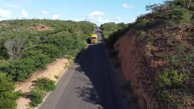 Truck passing in small charming newly paved road in the savannah of northeastern Brazil, the sertão