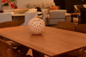 round rattan lamp, table and rattan lamp on wooden table, decoration with rattan balls, brazilian handicraft, interior design accessory, natural and handcrafted decor