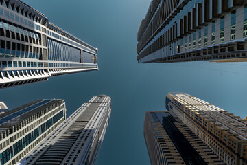 skyscrapers in dubai view from bottom with deep blue sky