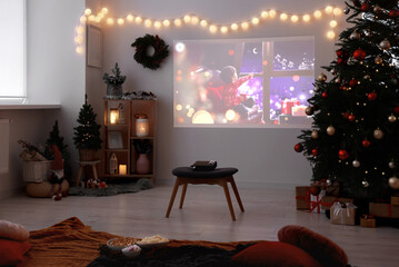 Video projector, Christmas tree, snacks, gifts and decorations in room