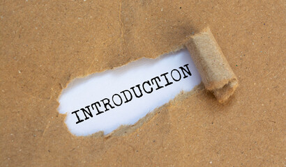INTRODUCTION, text on white paper on torn paper background