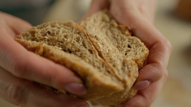 baker showing hot cut freshly baked crispy and puffy bread bun bakery baking production professional kitchen close up