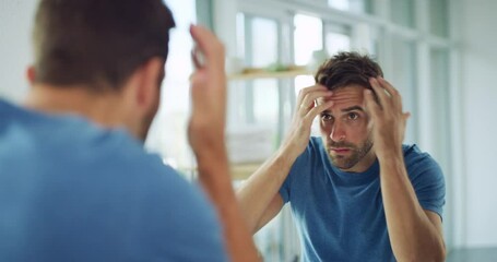 Reflection, man in bathroom fixing hair and morning routine of cleaning glow, checking hairstyle and self care. Grooming, haircare and male looking in mirror with hands on head getting ready in home.