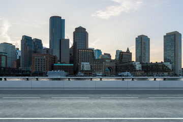 Empty urban asphalt road exterior with city buildings background. New modern highway concrete construction. Concept of way to success. Transportation logistic industry fast delivery. Boston. USA.