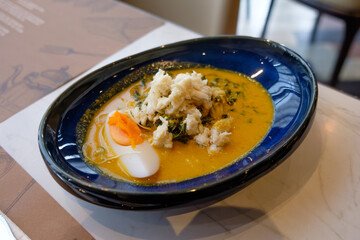Rice Noodles with Thai aromatic crab green curry serve in luxury ceramic plate