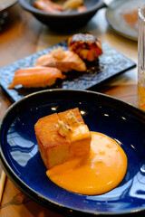 Brioche toast with salted egg sauce and plate of Sushi serve in restaurant