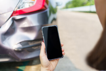 Asian woman got a car accident or car crash and using smartphone to call for road side emergency...