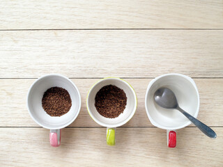 instant coffee and silver stainless teaspoon in cup on desk with copy space