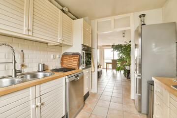 a kitchen with all white cabinets and appliances on the counter top in front of the sink is an open door