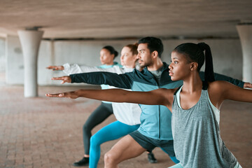 Team, exercise and friends stretching as a fitness club for sports, health and wellness in an urban class together. Sport, commitment and people training or group doing pilates workout in yoga