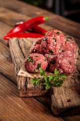 fresh raw beef meatballs with parsley