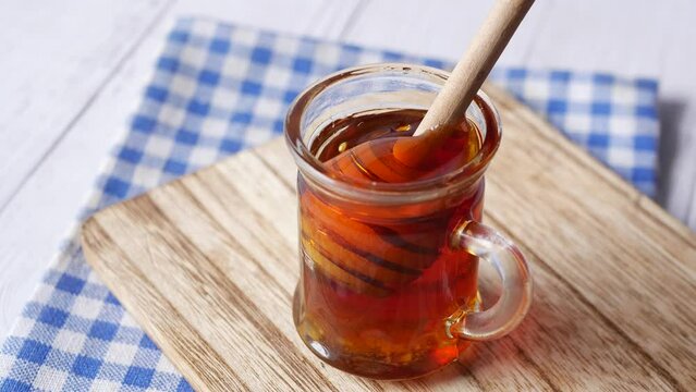 close up of fresh honey with spoon on table 