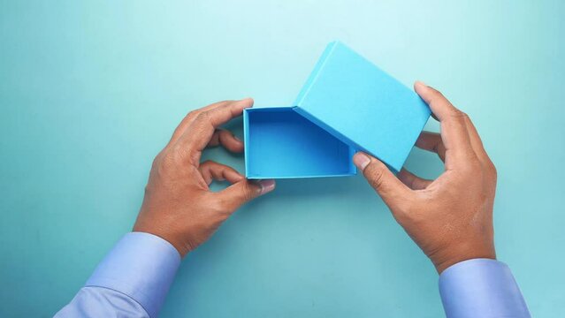 top view of person open a empty small gift box 