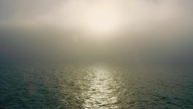Breathtaking early morning view of ocean with thick fog creating a magical haze