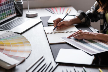 Graphic designer working with sketching logo design at office.