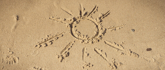 Shape of sun on sand at beach. Summer and vacation time