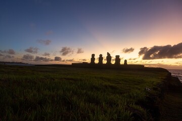 Sunset at Famous Tahai Archaeological site with Row of Moai Statues. Hanga Roa Waterfront, Easter Island Chile, Rapa Nui Pacific Coastline