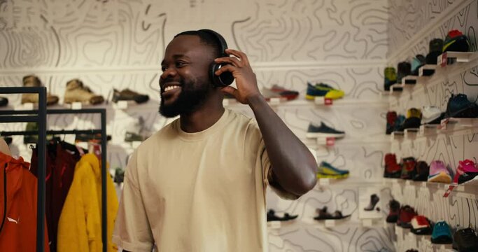 Musical Vibes: Afroamerican Man's Joyful Exploration in the Clothing and Footwear Store