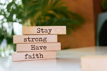 Wooden blocks with words 'Stay strong, have faith'.
