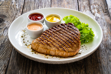 Grilled beef steak on wooden table