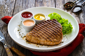 Grilled beef steak on wooden table