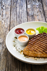 Grilled beef steak on wooden table