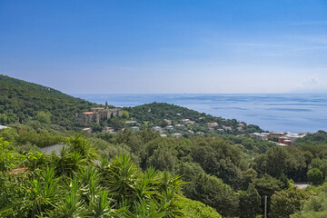 Fototapeta premium Corsica, a traditional village in the mountain, typical houses, with the sea in background 