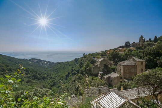 Corsica, a traditional village in the mountain, typical houses, with the sea in background
